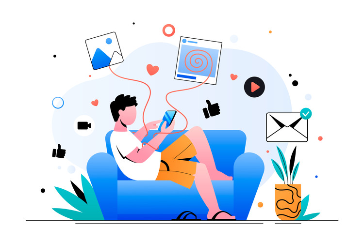Ein männlich gelesene Person sitzt auf einem blauen Sofa und hält ein 